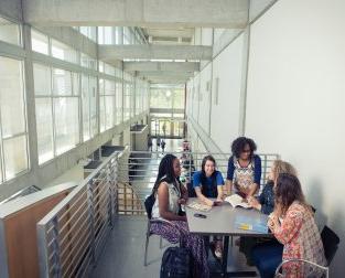 People at a table sharing a book